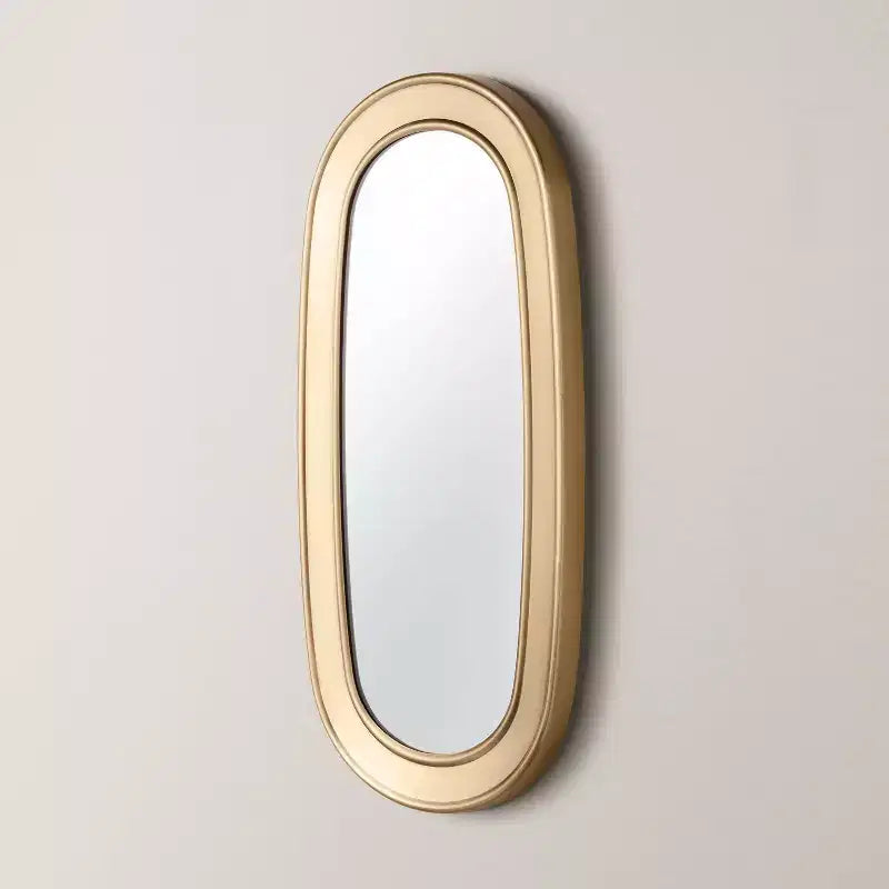 Specchio ovale con finitura in ottone