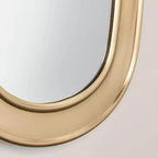 Specchio ovale con finitura in ottone