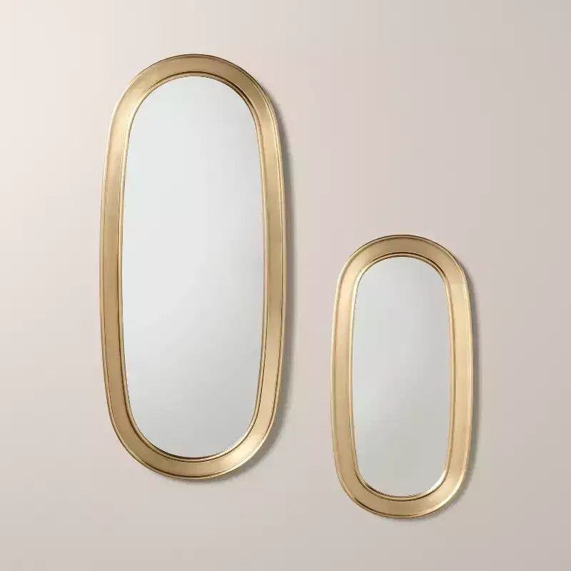 Specchio ovale con finitura in ottone